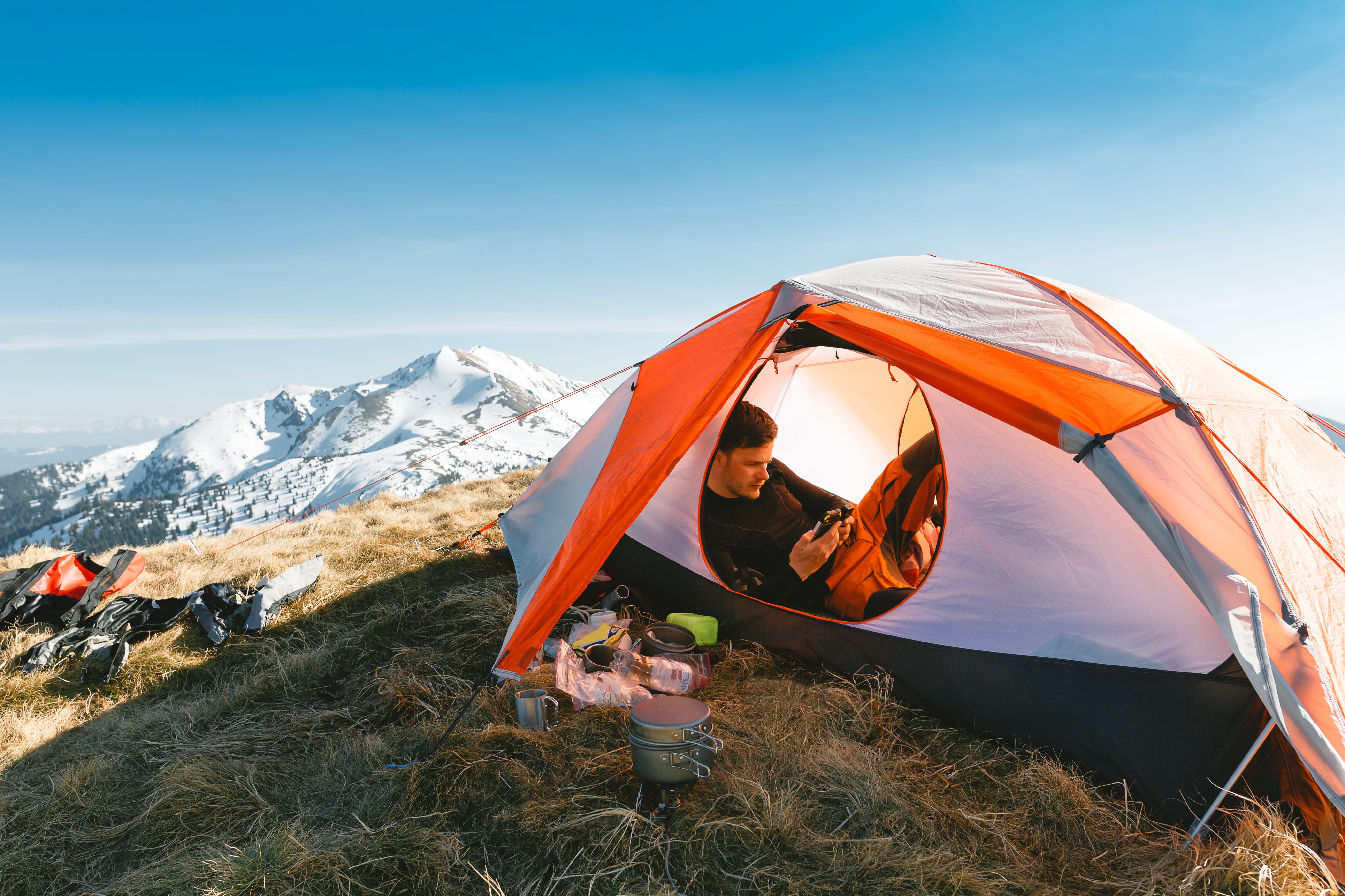 Male in a tent on a mountain top