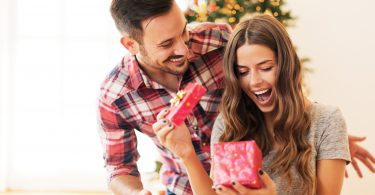 happy young couple opening present