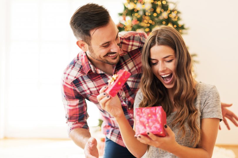 happy young couple opening present