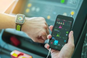 Man Comparing Activity App and check on Apple Watch and iPhone before running working out