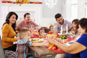 Latino family eating thanksgiving dinner together