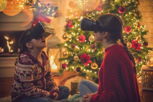 kids using virtual reality headsets in front of a Christmas tree