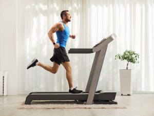 man exercising on treadmill at home