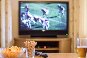 tv playing football in the background of a living room