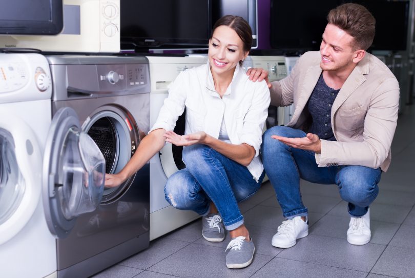 husband and wife shopping for a washing machine