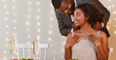 man giving woman necklace as present for valentine's day
