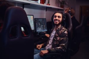 happy PC gamer sitting in gaming chair
