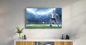 TV hanging on a wall playing a soccer match