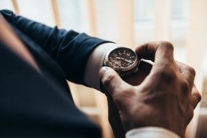 man in suit looking at watch