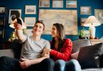 Young couple excited about watching TV