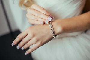 woman admiring her silver bracelet on her wrist