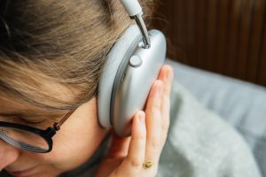 woman using AirPods Max in her bedroom 