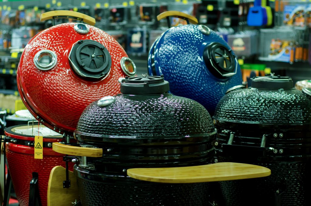 four kamado grills on display in a store