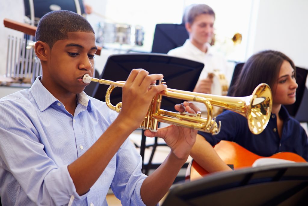 student practicing instrument in band class
