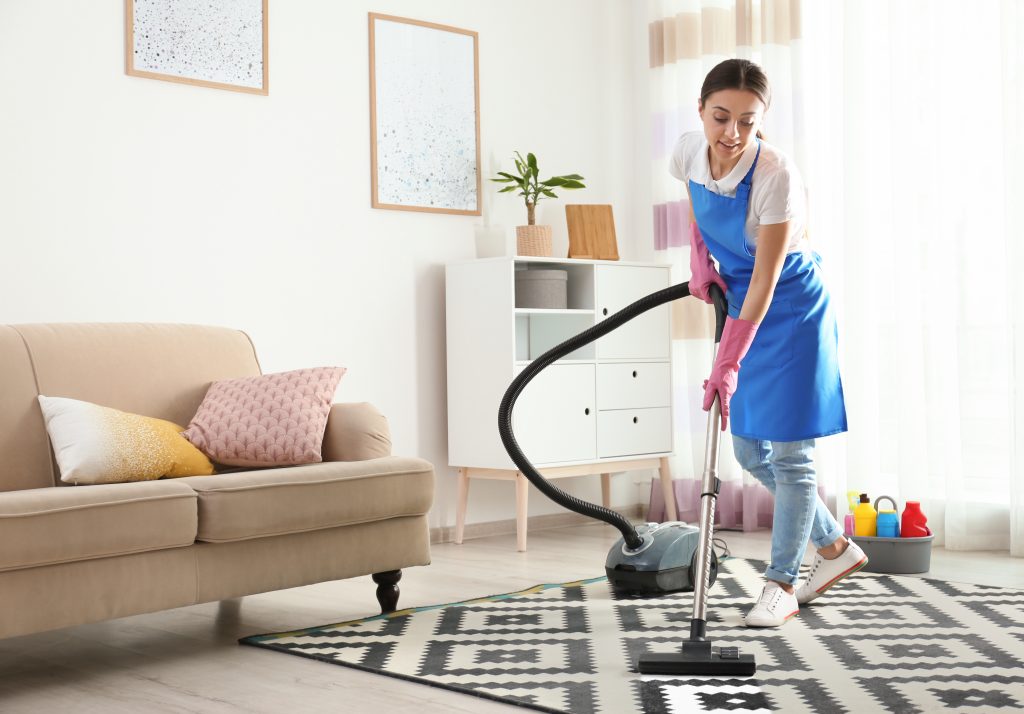 Woman vacuuming,carpet in living room