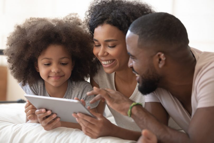 Happy family browsing a tablet at home