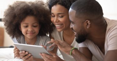 Happy family browsing a tablet at home
