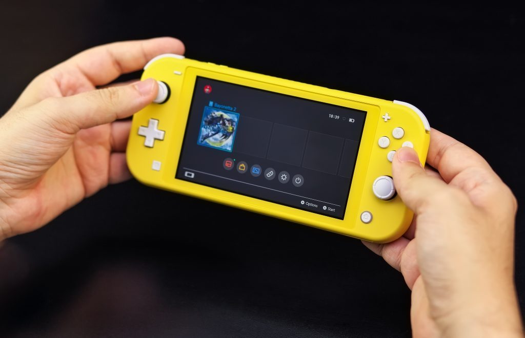 young person playing Nintendo Switch Lite
