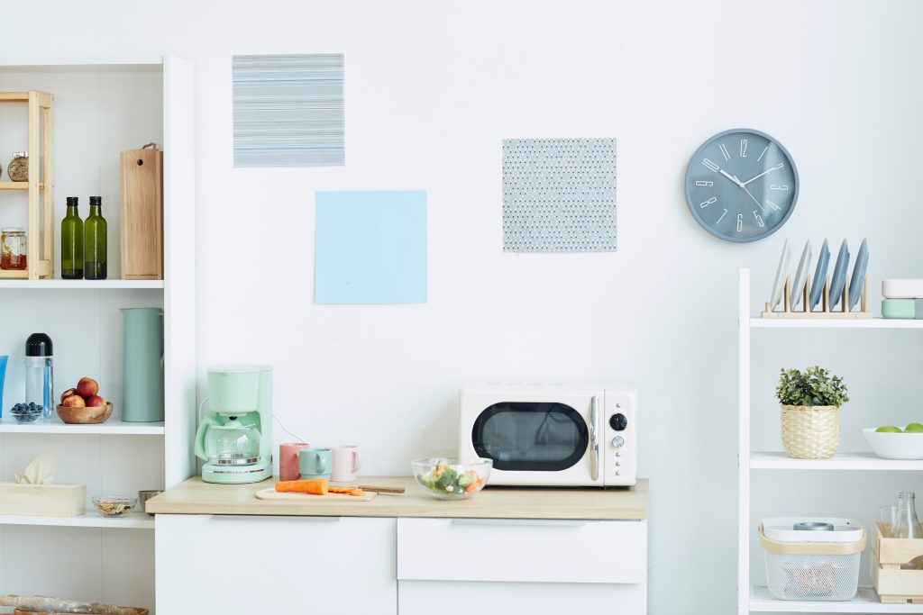 Dorm kitchen in fresh sea-green and light blue colors with coffeemaker and microwave