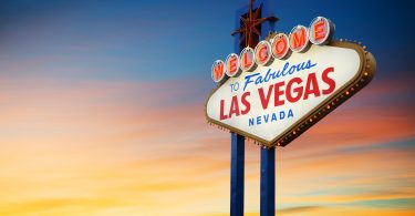 Lit up Las Vegas sign at sunset